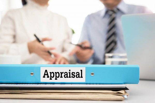 Blue-appraisal-folder-with-meeting-in-background-600x401