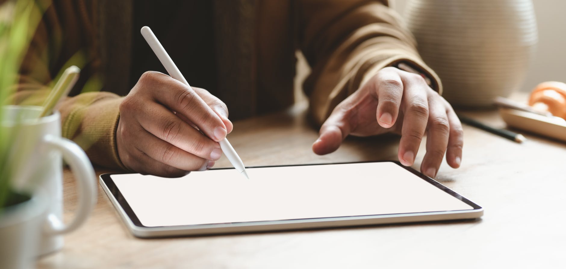 person writing on tablet